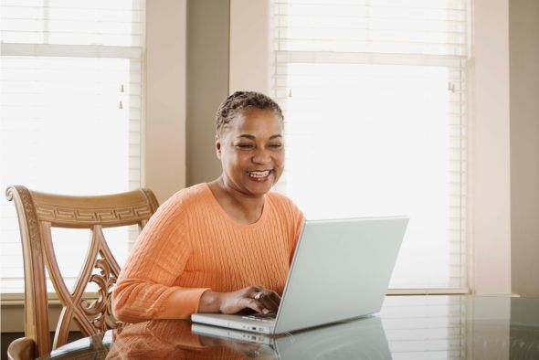 hotelier using automated reservation system on laptop